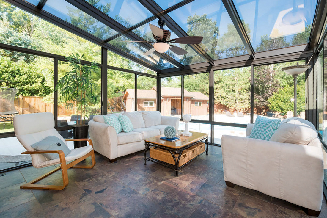 a room with a glass ceiling and a ceiling fan